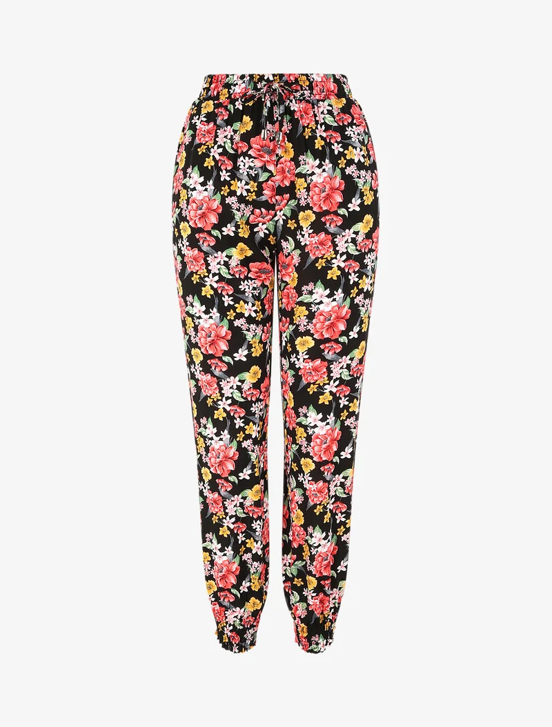 Fließende Hose mit Frühlingsblumenmuster und elastischen Säumen. - Schwarz