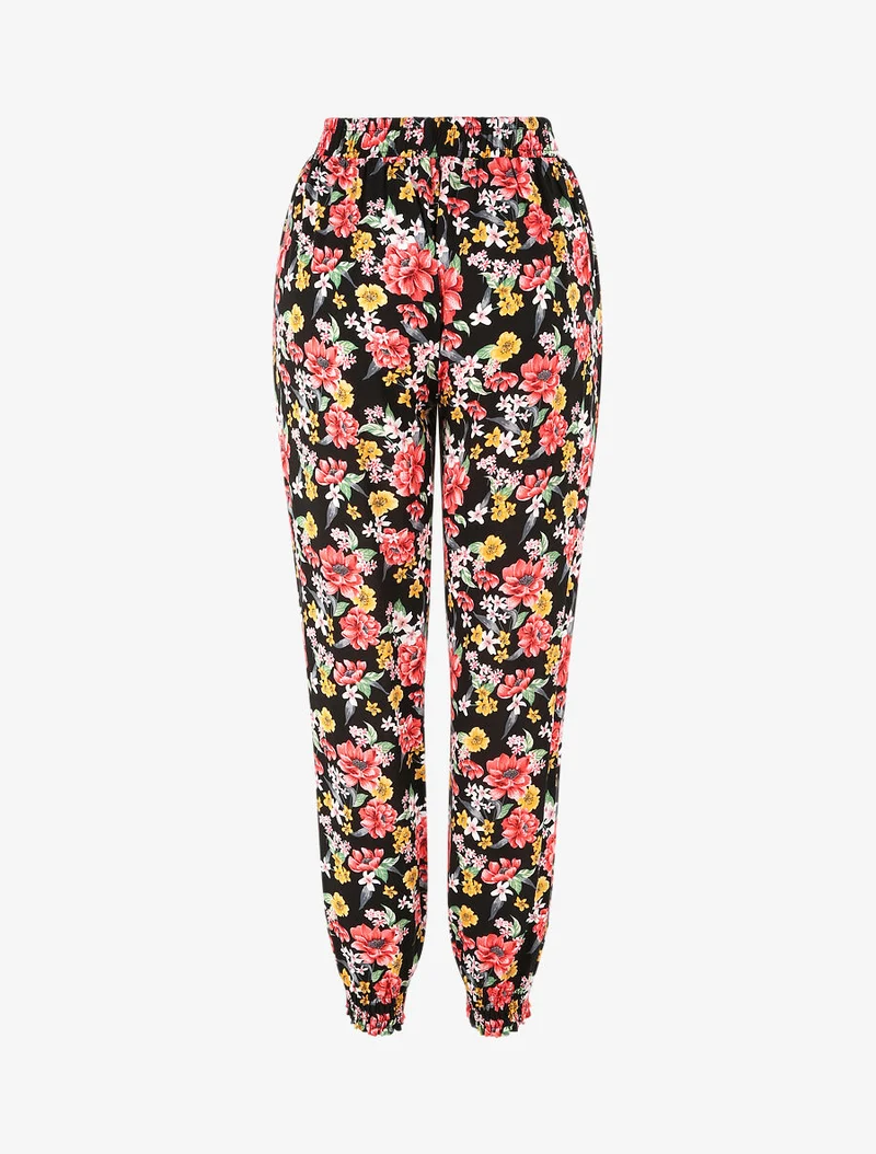 Fließende Hose mit Frühlingsblumenmuster und elastischen Säumen. - Schwarz