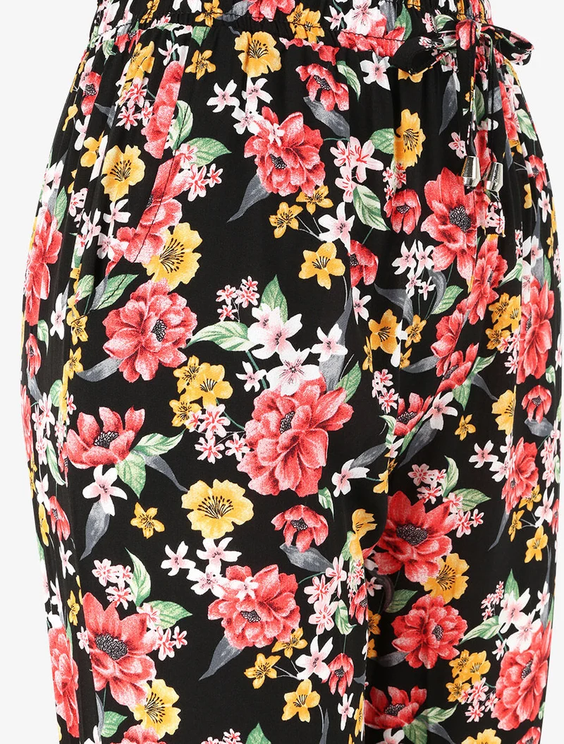 Fließende Hose mit Frühlingsblumenmuster und elastischen Säumen. - Schwarz