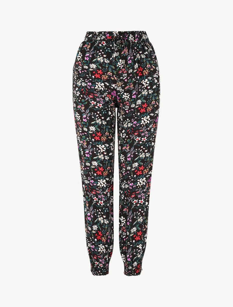 Fließende Hose mit kleinem Blumenmuster und elastischen Bündchen - Schwarz