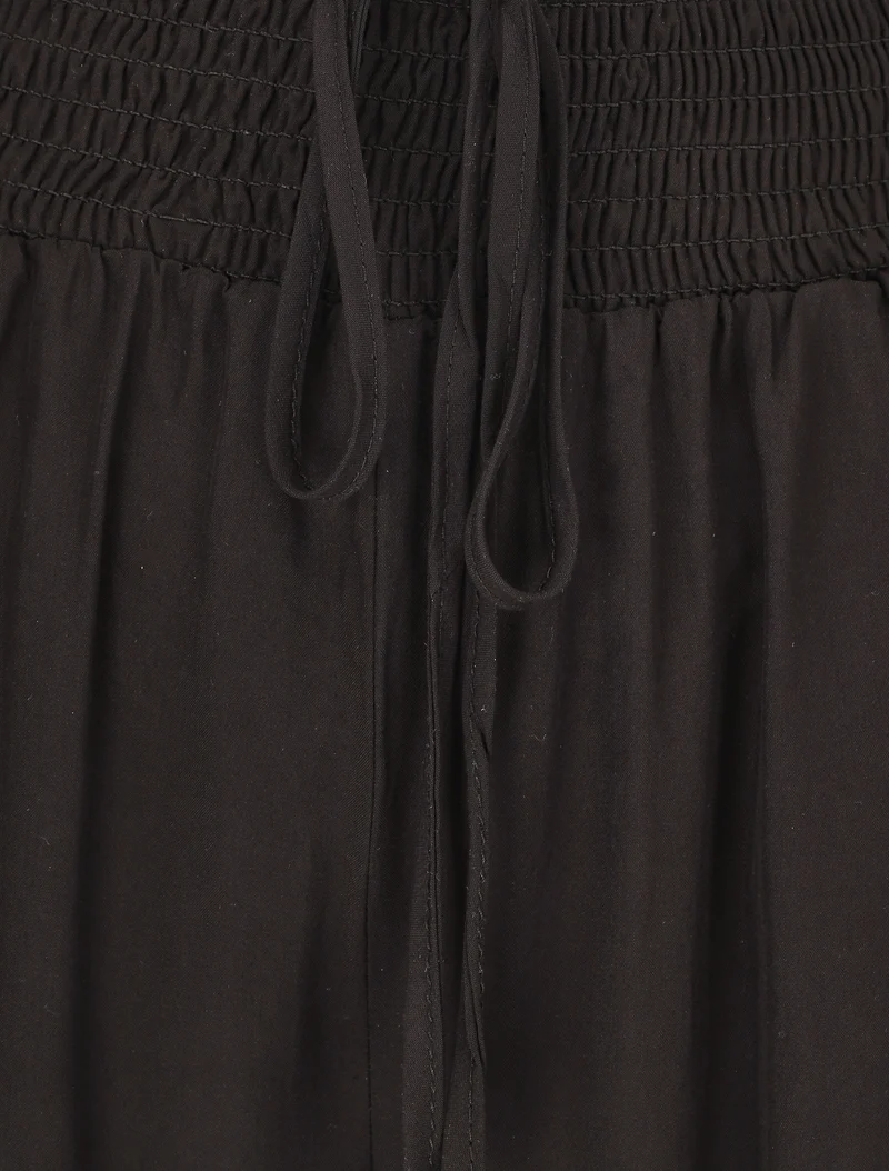 Einfarbige fließende Hose mit Taschen - Schwarz