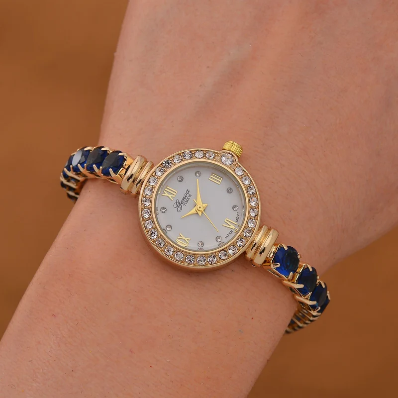 Genoa Time V2 - PC21S Japanisches Uhrwerk, Gehäuse mit weißen Kristallakzenten und PNP-Goldplattierung, runder Zifferblatt mit weißen Ziffern und Kristallen, Kupferkette mit blauen Zirkonia