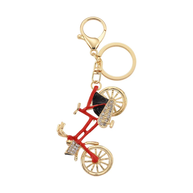 3er-Set emaillierte weiße, schwarze und rosa Kristall-Schlüsselanhänger mit Fahrrad, Kamel und geflügelter Ballerina, Legierung in Gelbgold