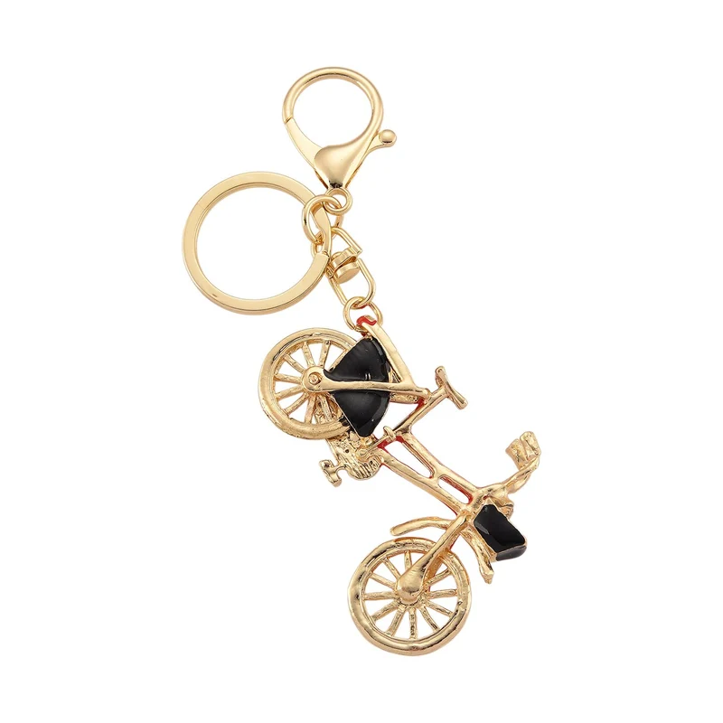 3er-Set emaillierte weiße, schwarze und rosa Kristall-Schlüsselanhänger mit Fahrrad, Kamel und geflügelter Ballerina, Legierung in Gelbgold